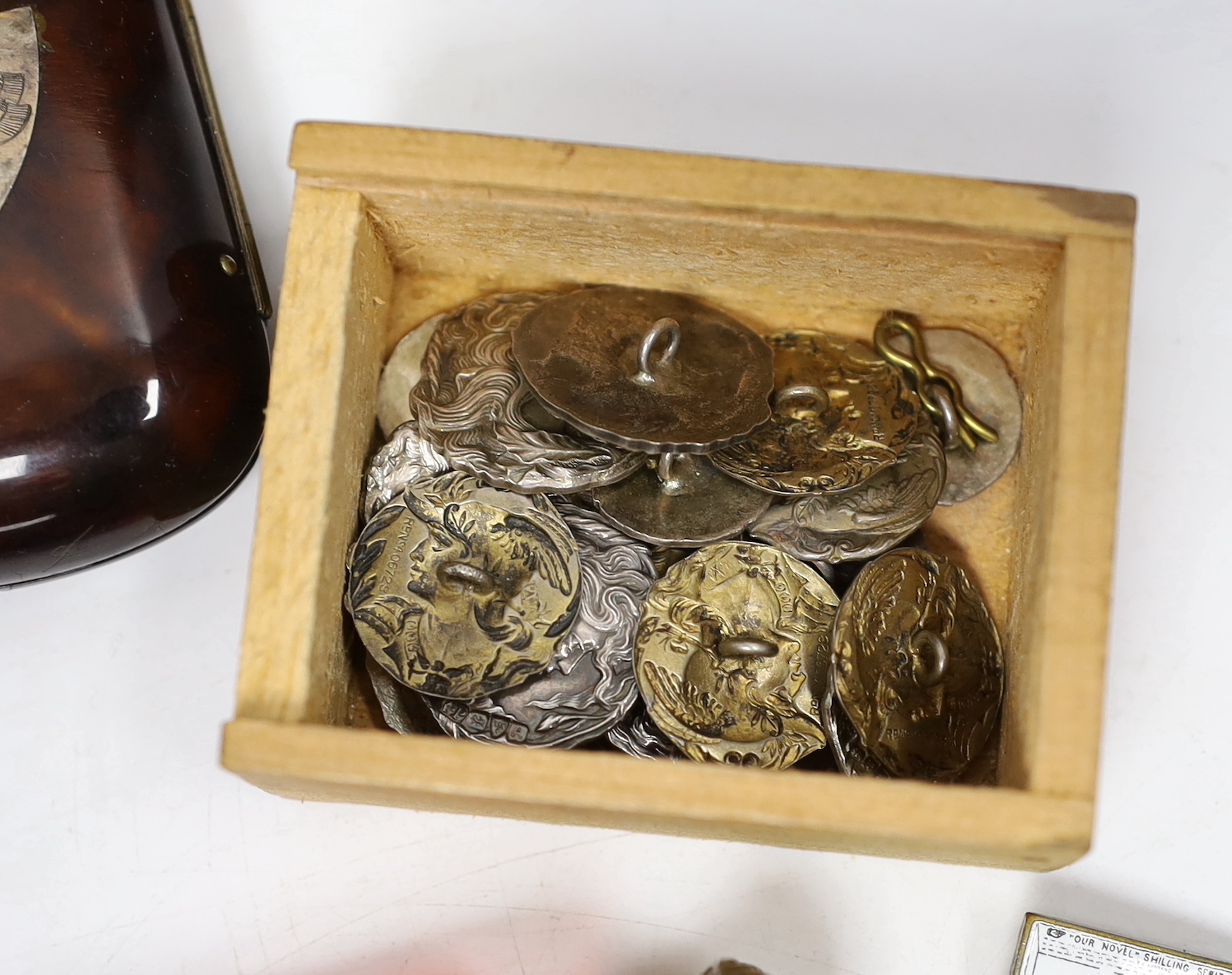 A group of vertu to include an unusual Victorian white metal mounted green glass combination scent bottle and whistle, a group of Art Nouveau silver buttons, carved tortoiseshell boxes, a double ended scent bottle etc.